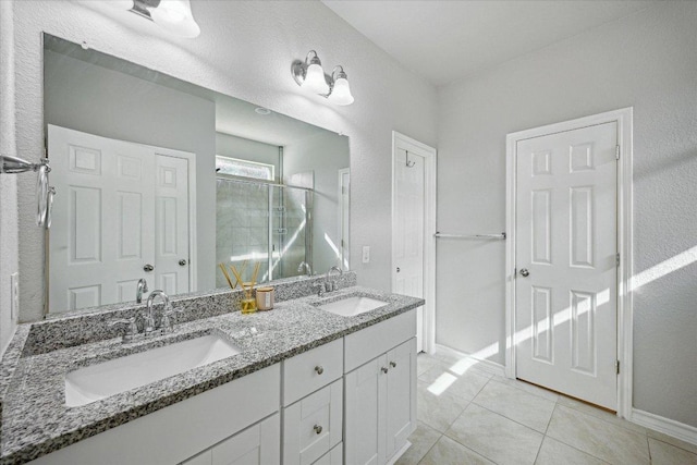 604 John Muir Trl, Leander, TX 78641 - full bath featuring double vanity, tile patterned floors, and an enclosed shower