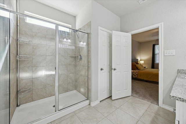 604 John Muir Trl, Leander, TX 78641 - ensuite bathroom featuring a stall shower and tile patterned flooring