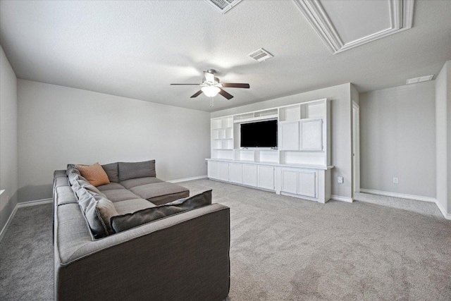 604 John Muir Trl, Leander, TX 78641 - living room featuring a ceiling fan, light colored carpet, a textured ceiling, and attic access
