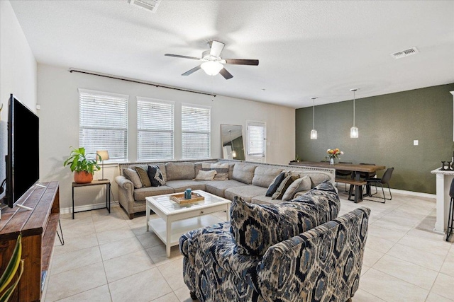 604 John Muir Trl, Leander, TX 78641 - living room with ceiling fan, light tile patterned floors, and a textured ceiling