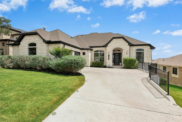 15408 Joseph Dr, Austin, TX 78734 - french provincial home with stone siding, concrete driveway, an attached garage, and a front lawn