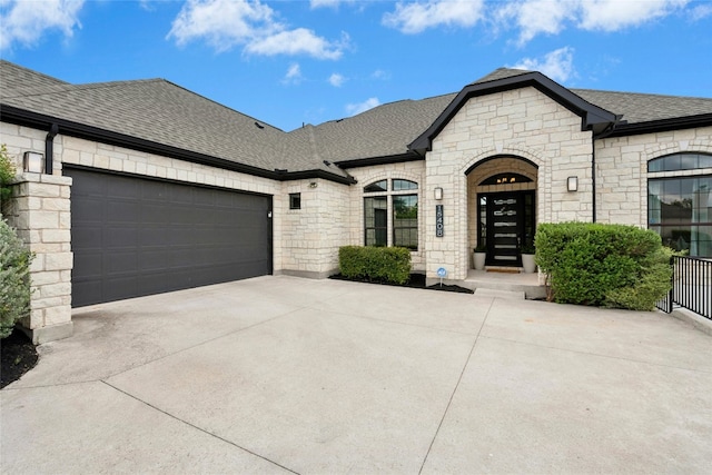 15408 Joseph Dr, Austin, TX 78734 - french country inspired facade with stone siding, driveway, roof with shingles, and an attached garage