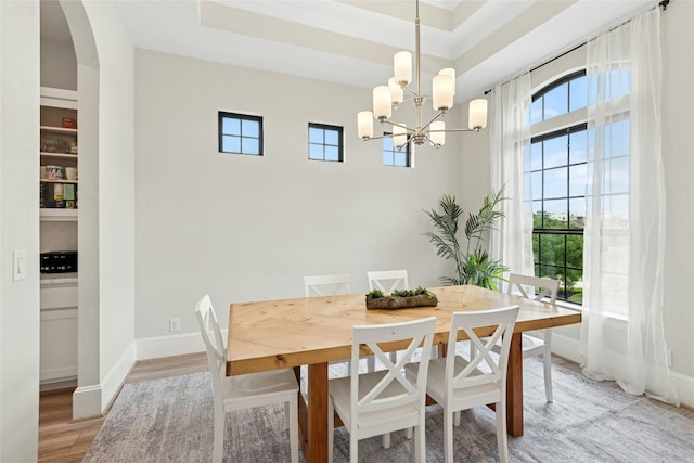 15408 Joseph Dr, Austin, TX 78734 - dining area with a chandelier, light wood finished floors, and arched walkways
