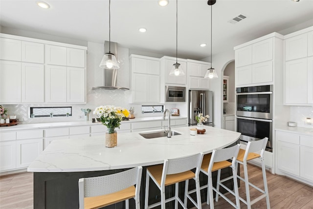 15408 Joseph Dr, Austin, TX 78734 - kitchen with stainless steel appliances, decorative backsplash, arched walkways, and recessed lighting