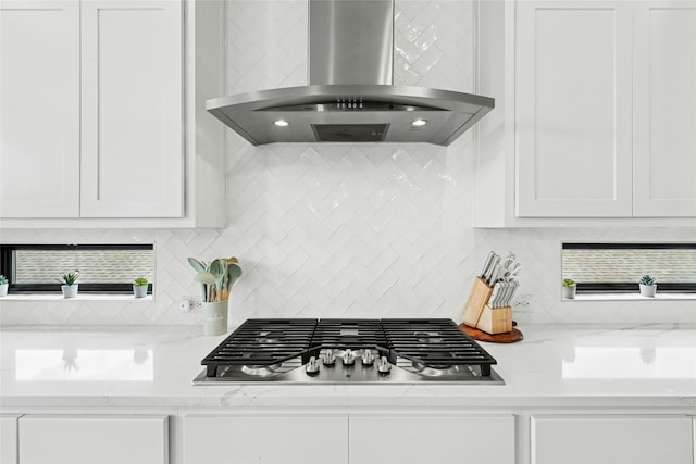15408 Joseph Dr, Austin, TX 78734 - kitchen featuring wall chimney exhaust hood, stainless steel gas stovetop, white cabinets, decorative backsplash, and light stone countertops