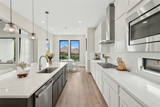15408 Joseph Dr, Austin, TX 78734 - kitchen with wall chimney exhaust hood, stainless steel appliances, white cabinets, light wood finished floors, and tasteful backsplash