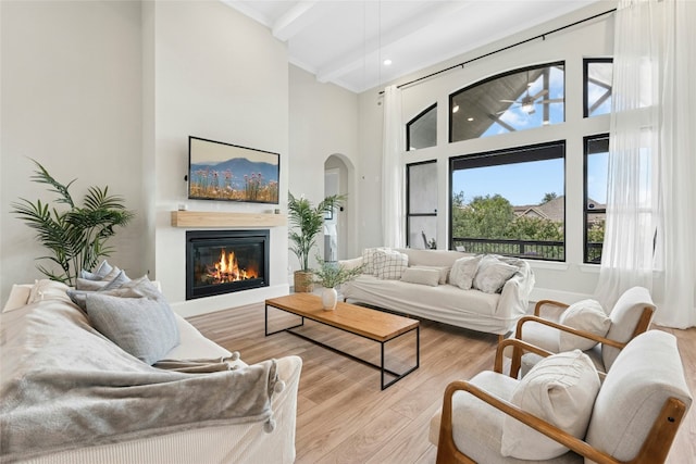 15408 Joseph Dr, Austin, TX 78734 - living area featuring a high ceiling, wood finished floors, a glass covered fireplace, beamed ceiling, and recessed lighting