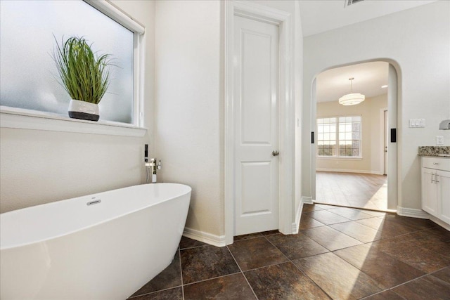 3207 Crystal Falls Pkwy, Leander, TX 78641 - bathroom with a freestanding tub and vanity