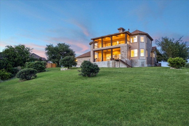 3207 Crystal Falls Pkwy, Leander, TX 78641 - back of house with a lawn, stairway, and a balcony