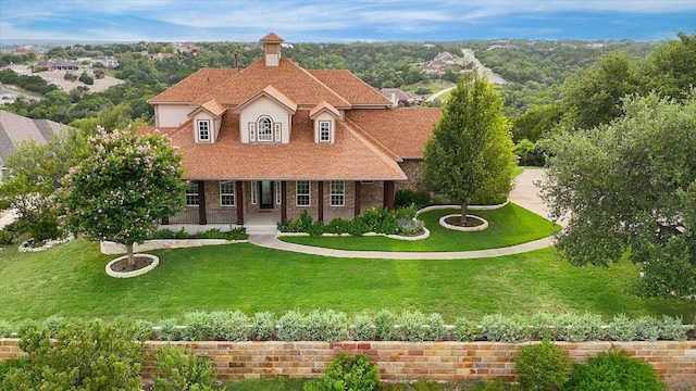 3207 Crystal Falls Pkwy, Leander, TX 78641 - view of front facade featuring covered porch, a front lawn, a chimney, and a shingled roof