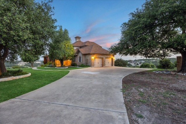 3207 Crystal Falls Pkwy, Leander, TX 78641 - view of front facade with concrete driveway, an attached garage, a yard, and stone siding