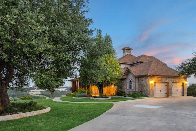 3207 Crystal Falls Pkwy, Leander, TX 78641 - view of front of property featuring concrete driveway, an attached garage, a front yard, a chimney, and brick siding