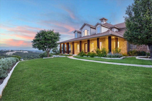 3207 Crystal Falls Pkwy, Leander, TX 78641 - view of front of house featuring a porch, a front yard, and brick siding