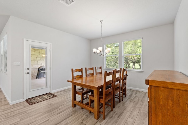 127 Tom Kite Dr, Burnet, TX 78611 - dining area with light wood finished floors and a chandelier