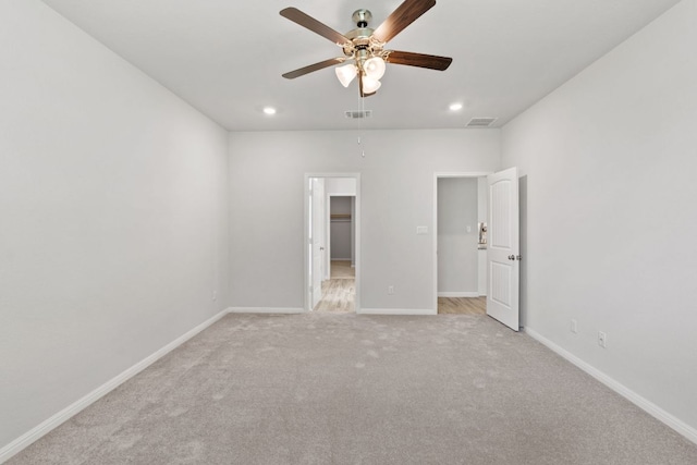 127 Tom Kite Dr, Burnet, TX 78611 - unfurnished bedroom featuring a walk in closet, light colored carpet, recessed lighting, and a ceiling fan
