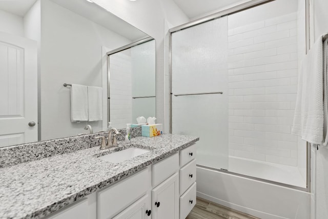 127 Tom Kite Dr, Burnet, TX 78611 - full bathroom with vanity, wood finished floors, and combined bath / shower with glass door