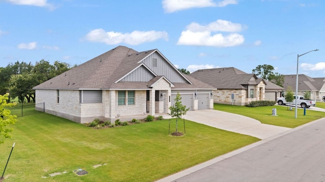 127 Tom Kite Dr, Burnet, TX 78611 - view of front of home featuring board and batten siding, stone siding, driveway, a garage, and roof with shingles