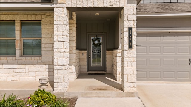 127 Tom Kite Dr, Burnet, TX 78611 - property entrance featuring a garage and stone siding