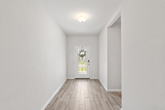 127 Tom Kite Dr, Burnet, TX 78611 - doorway with light wood finished floors and baseboards