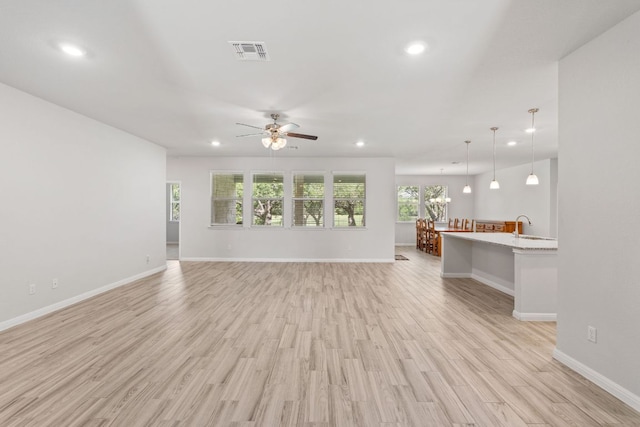 127 Tom Kite Dr, Burnet, TX 78611 - unfurnished living room featuring recessed lighting, ceiling fan, and light wood-style floors