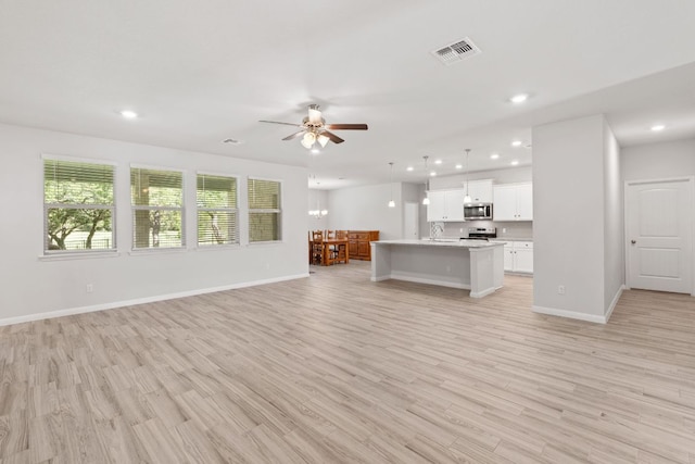 127 Tom Kite Dr, Burnet, TX 78611 - unfurnished living room featuring ceiling fan, recessed lighting, and light wood-type flooring