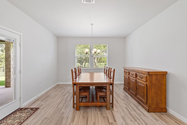 127 Tom Kite Dr, Burnet, TX 78611 - dining space featuring light wood-style flooring and a chandelier