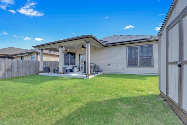 14200 James Garfield St, Manor, TX 78653 - back of property with ceiling fan, roof mounted solar panels, a patio area, and an outdoor living space