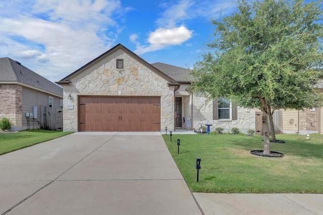 14200 James Garfield St, Manor, TX 78653 - french country inspired facade with stone siding, an attached garage, a front yard, and driveway