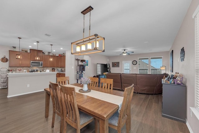 14200 James Garfield St, Manor, TX 78653 - dining room with wood finished floors, ceiling fan, and recessed lighting