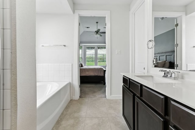 8100 Copper Prairie Bnd, Lago Vista, TX 78645 - bathroom with connected bathroom, a ceiling fan, a garden tub, vanity, and tile patterned floors