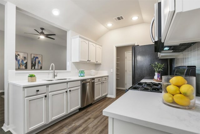 216 Watergate Way, Hutto, TX 78634 - kitchen with appliances with stainless steel finishes, a ceiling fan, dark wood-style flooring, light countertops, and white cabinets