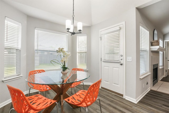216 Watergate Way, Hutto, TX 78634 - dining space featuring a chandelier, wood finished floors, and a fireplace with flush hearth
