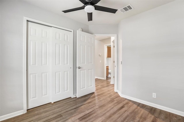 216 Watergate Way, Hutto, TX 78634 - unfurnished bedroom featuring wood finished floors, a closet, and a ceiling fan