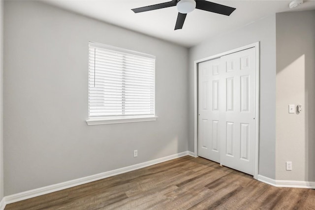 216 Watergate Way, Hutto, TX 78634 - unfurnished bedroom with wood finished floors, a closet, and a ceiling fan