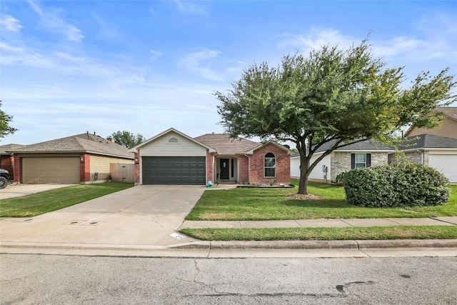 216 Watergate Way, Hutto, TX 78634 - ranch-style home featuring a front yard, brick siding, an attached garage, and driveway
