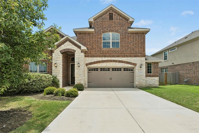 2309 Lone Spur Cv, Round Rock, TX 78665 - view of front of property featuring stone siding, driveway, brick siding, and an attached garage