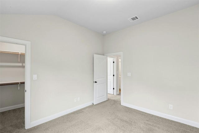 2309 Lone Spur Cv, Round Rock, TX 78665 - unfurnished bedroom featuring a spacious closet, vaulted ceiling, carpet flooring, and a closet