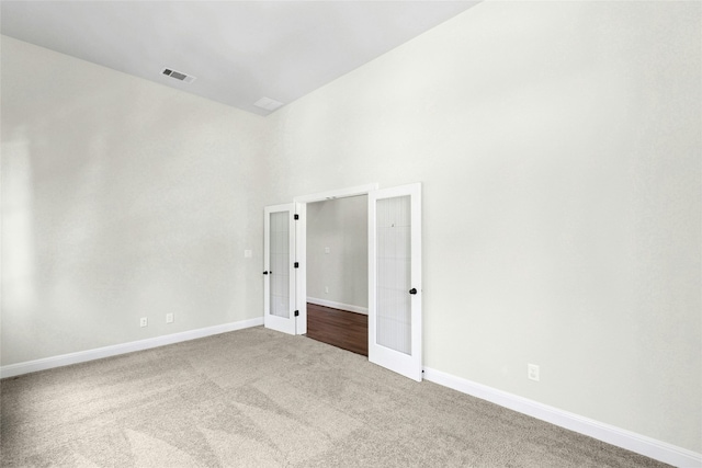 2309 Lone Spur Cv, Round Rock, TX 78665 - carpeted empty room featuring french doors and a high ceiling