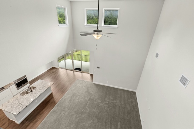 2309 Lone Spur Cv, Round Rock, TX 78665 - unfurnished living room featuring dark wood finished floors and ceiling fan