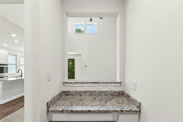 2309 Lone Spur Cv, Round Rock, TX 78665 - bathroom with a textured wall, wood finished floors, and healthy amount of natural light