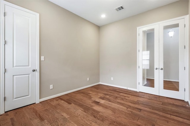 1821 Cherry Glade Trl, Georgetown, TX 78628 - spare room featuring french doors, wood finished floors, and recessed lighting