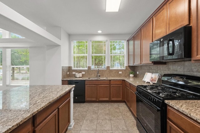 1267 Sanders, Kyle, TX 78640 - kitchen with black appliances, decorative backsplash, light stone counters, brown cabinetry, and recessed lighting