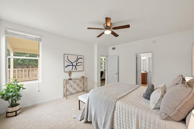 1267 Sanders, Kyle, TX 78640 - carpeted bedroom with connected bathroom and ceiling fan
