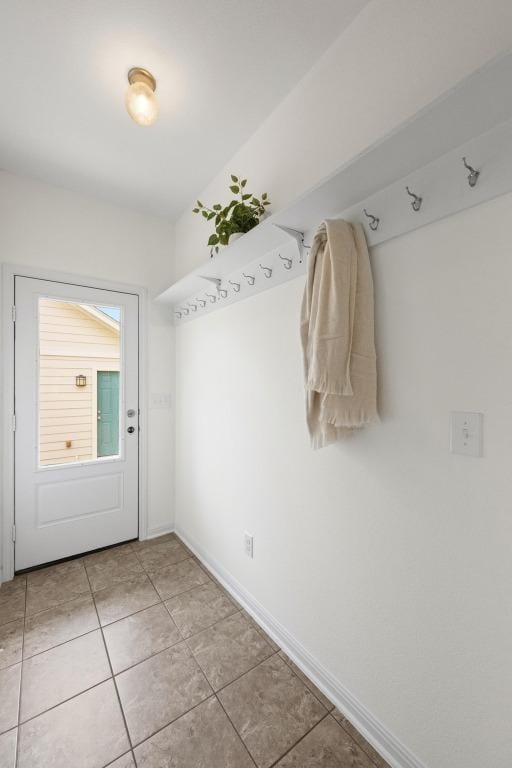 1267 Sanders, Kyle, TX 78640 - doorway to outside featuring light tile patterned floors and baseboards