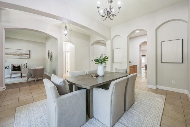 112 Mcbride Ln, Cedar Park, TX 78613 - dining room with light tile patterned floors, arched walkways, and a chandelier