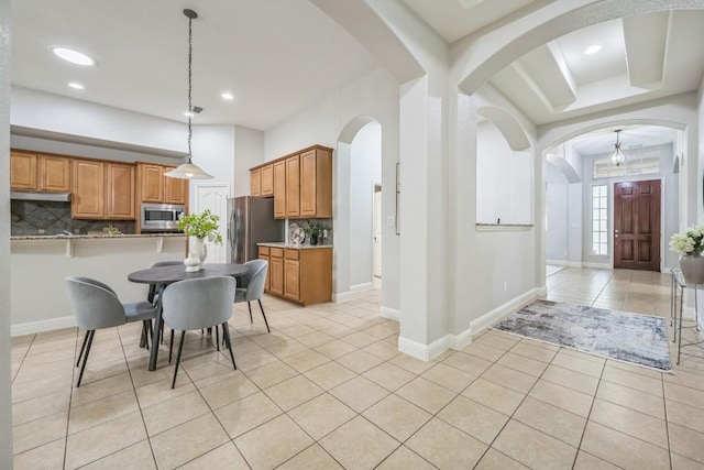 112 Mcbride Ln, Cedar Park, TX 78613 - dining space with light tile patterned flooring, arched walkways, and recessed lighting