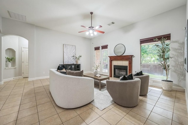 112 Mcbride Ln, Cedar Park, TX 78613 - living room featuring light tile patterned floors, a tile fireplace, and healthy amount of natural light