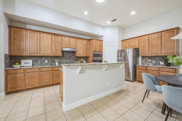 112 Mcbride Ln, Cedar Park, TX 78613 - kitchen featuring appliances with stainless steel finishes, under cabinet range hood, light tile patterned floors, tasteful backsplash, and recessed lighting