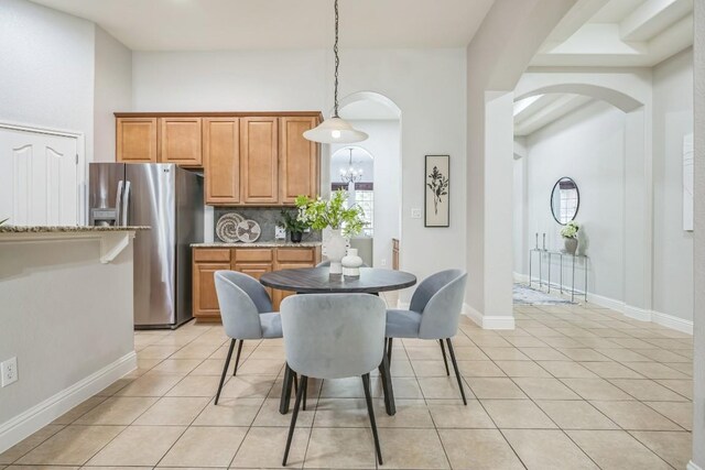 112 Mcbride Ln, Cedar Park, TX 78613 - dining room featuring arched walkways, light tile patterned flooring, and a chandelier