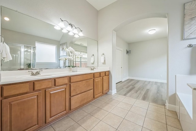 112 Mcbride Ln, Cedar Park, TX 78613 - full bath featuring double vanity, a garden tub, a stall shower, and tile patterned flooring